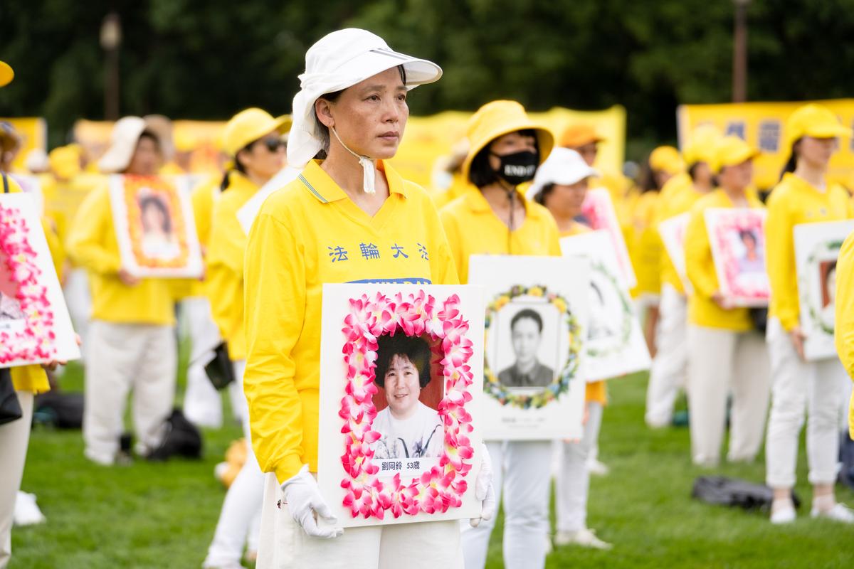Falun Gong practitioners take part in a rally held in at the National Mall, Washington, on July 21, 2022, to commemorate the 23rd anniversary of the launch of the Chinese regime's persecution of spiritual group Falun Gong. (Samira Bouaou/The Epoch Times)