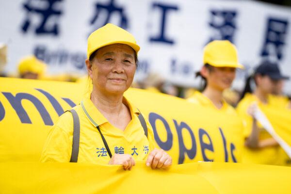 Falun Gong practitioners take part in a rally held at the National Mall, Washington, on July 21, 2022. They commemorate the 23rd anniversary of the launch of the Chinese regime's persecution of the spiritual group Falun Gong. (Samira Bouaou/The Epoch Times)
