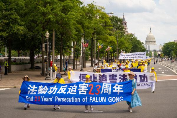 Falun Gong practitioners march down Constitution Avenue to commemorate the 23rd anniversary of the Chinese Communist Party's persecution of the spiritual practice in China, in Washington on July 21, 2022. (Samira Bouaou/The Epoch Times)