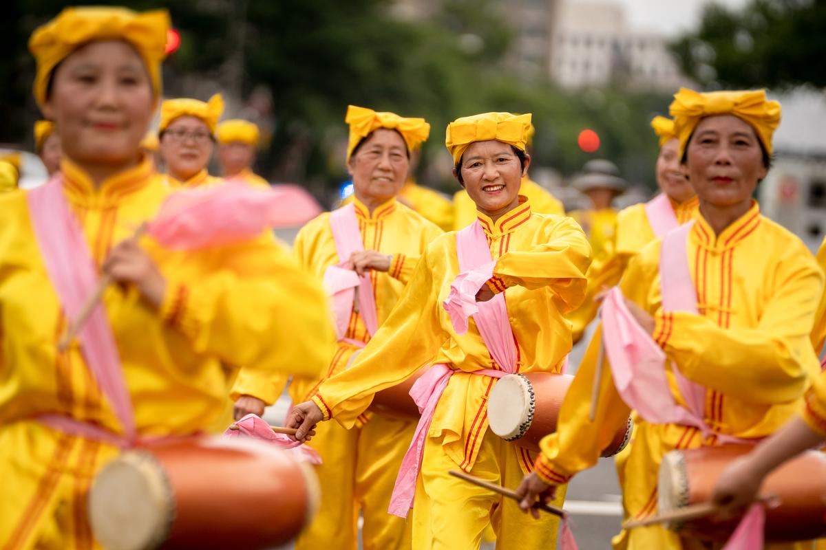 Falun Gong practitioners march down Pennsylvania Avenue to commemorate the 23rd anniversary of the Chinese Communist Party's persecution of the spiritual practice in China, in Washington on July 21, 2022. (Samira Bouaou/The Epoch Times)