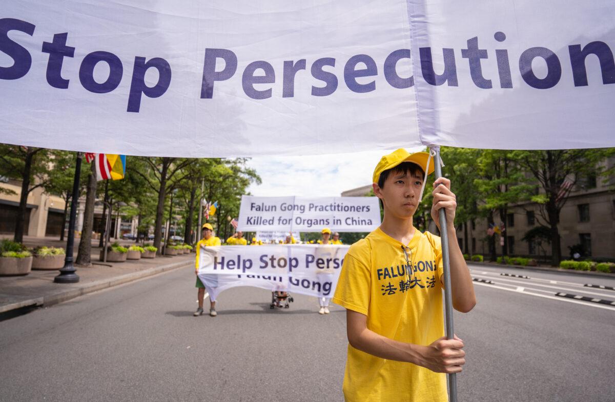 Falun Gong practitioners march downPennsylvania Avenue to commemorate the 23rd anniversary of the Chinese Communist Party's persecution of the spiritual practice in China, in Washington on July 21, 2022. (Samira Bouaou/The Epoch Times)