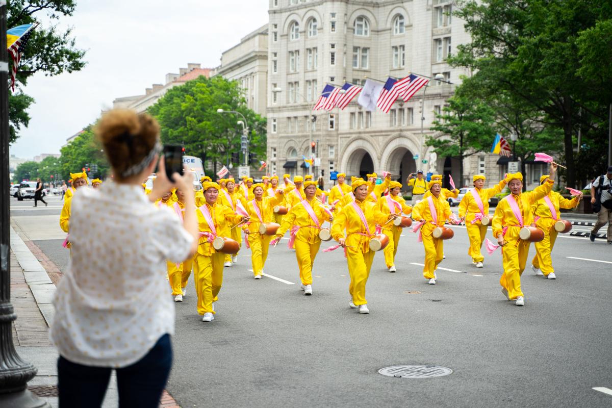 Falun Gong practitioners march down Pennsylvania Avenue to commemorate the 23rd anniversary of the Chinese Communist Party's persecution of the spiritual practice in China, in Washington on July 21, 2022. (Chung I Ho/ The Epoch Times)