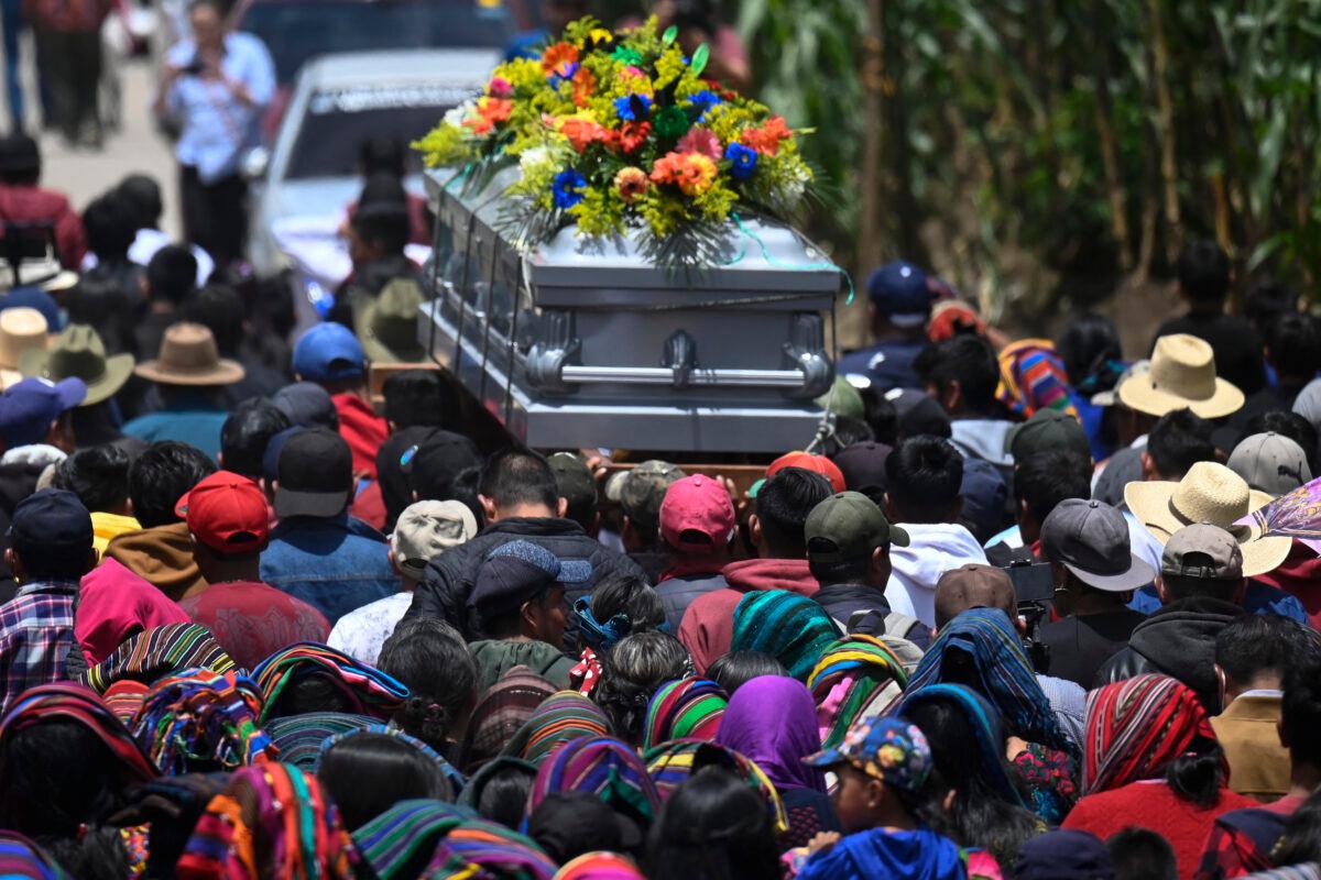 Indigenous people carry the coffin of Melvin Guachiac, a 13-year-old Guatemalan teenager who was killed inside a tractor-trailer in Texas after crossing from Mexico, for his burial at the municipal cemetery in the hamlet of Tzucubal in the municipality of Nahuala, Solola Department, Guatemala, on July 16, 2022. (Johan Ordonez/AFP via Getty Images)