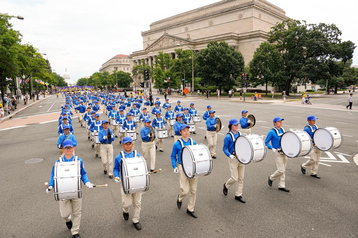 Falun Gong practitioners march down Pennsylvania Avenue to commemorate the 23rd anniversary of the Chinese Communist Party's persecution of the spiritual practice in China, in Washington on July 21, 2022. (Larry Dye/The Epoch Times)
