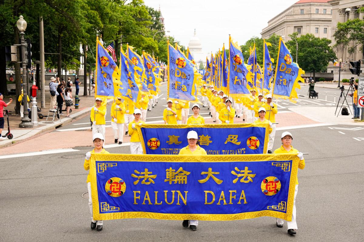 Falun Gong practitioners march down Pennsylvania Avenue to commemorate the 23rd anniversary of the Chinese Communist Party's persecution of the spiritual practice in China, in Washington on July 21, 2022. (Larry Dye/ The Epoch Times)