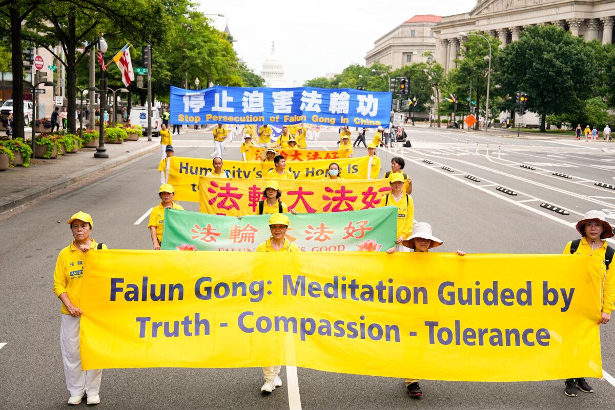 Falun Gong practitioners march down Pennsylvania Avenue to commemorate the 23rd anniversary of the Chinese Communist Party's persecution of the spiritual practice in China, in Washington on July 21, 2022. (Samira Bouaou/The Epoch Times)