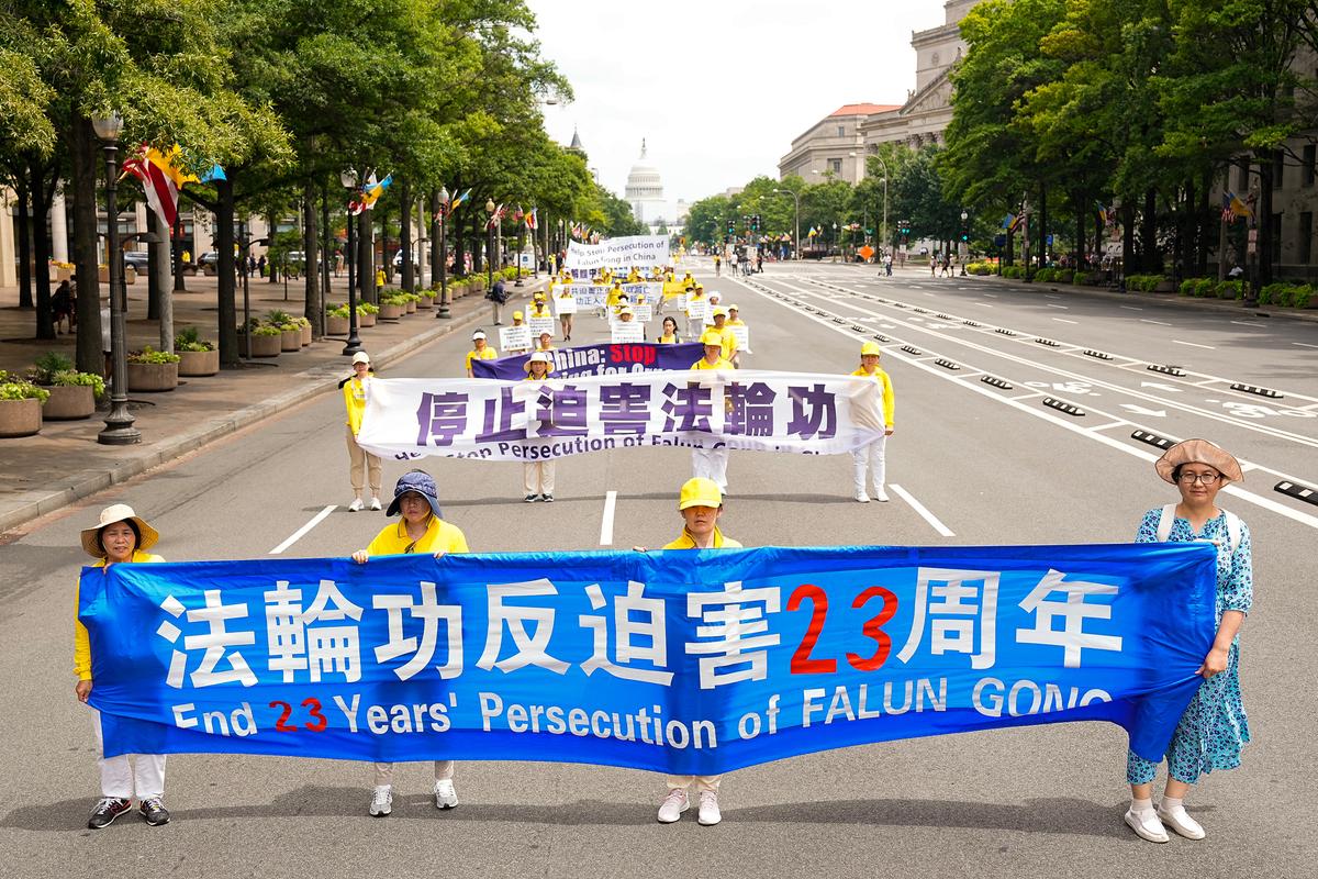 Falun Gong practitioners march down Pennsylvania Avenue to commemorate the 23rd anniversary of the Chinese Communist Party's persecution of the spiritual practice in China, in Washington on July 21, 2022. (Larry Dye/ The Epoch Times)