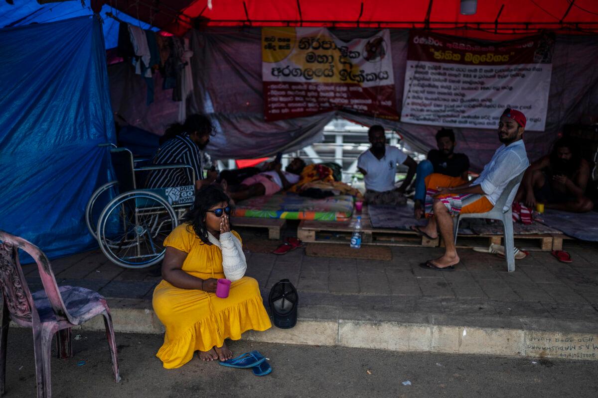 Protesters sit at their protest site in the morning in Colombo, Sri Lanka, on July 21, 2022. (Rafiq Maqbool/AP Photo)