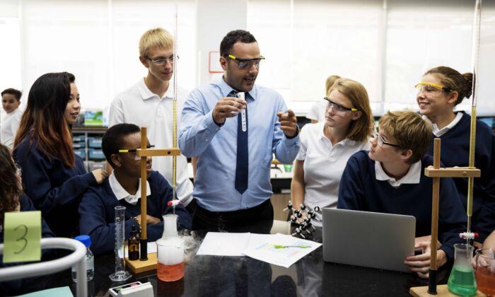 Group of students at laboratory lab in a science class. (ShutterStock)