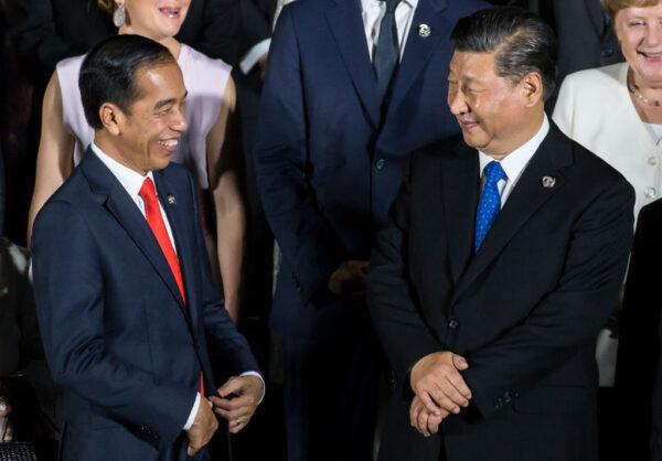 Indonesia's President Joko Widodo (L) and China's President Xi Jinping (R) during a photo session in front of Osaka Castle at the G-20 summit on June 28, 2019, in Osaka, Japan. (Photo by Tomohiro Ohsumi/Getty Images)
