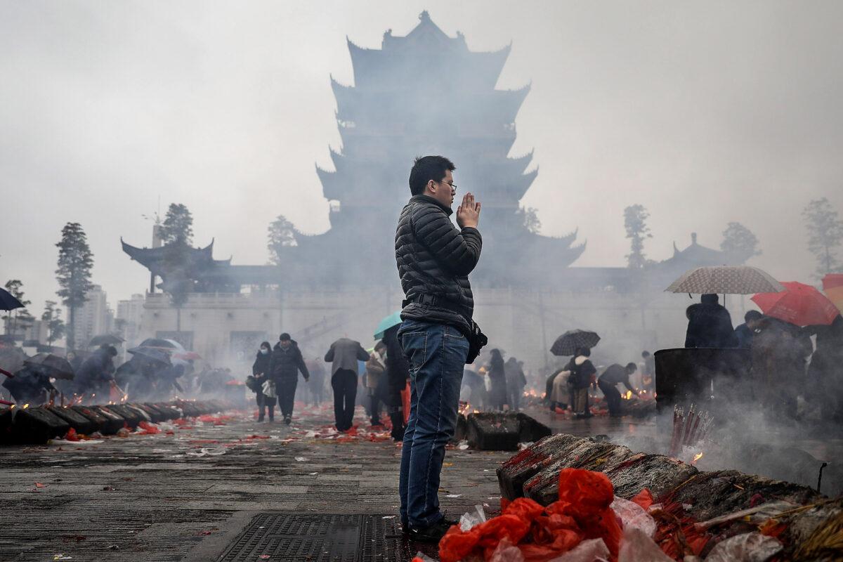 A man worships the God of Fortune at the Guiyuan Temple in Wuhan, Hubei Province, China, on Feb. 20, 2018. (Wang He/Getty Images)