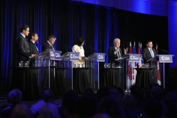 Conservative leadership hopeful Jean Charest (2nd R) speaks as (L-R) Pierre Poilievre, Patrick Brown, Scott Aitchison, Leslyn Lewis, and Roman Baber look on during the Conservative Party of Canada French-language leadership debate in Laval, Quebec, on May 25, 2022. (The Canadian Press/Ryan Remiorz)