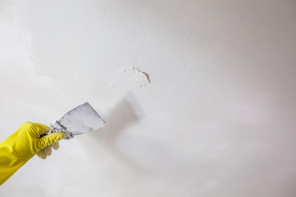 Apply spackle as needed to ensure you start with a smooth surface. (jantsarik/Shutterstock)