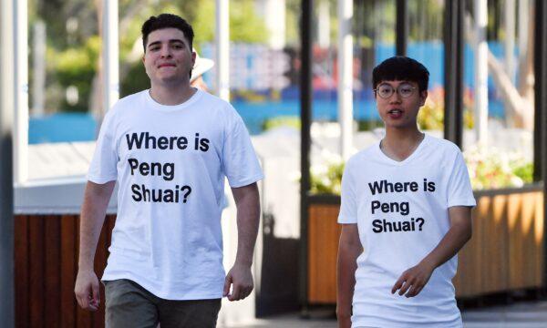 Australian human rights campaigner Drew Pavlou (L) is pictured wearing a "Where is Peng Shuai?" T-shirt, referring to the former women's tennis doubles world number one from China, outside one of the venues on day nine of the Australian Open tennis tournament in Melbourne on Jan. 25, 2022. (Paul Crock/AFP via Getty Images)