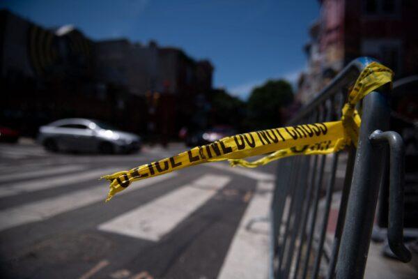 Police tape hangs from a barricade at the corner of South and 3rd Streets the day after three people were killed and 11 others wounded by gunfire within a few blocks in Philadelphia, on June 5, 2022. (Kriston Jae Bethel/AFP via Getty Images)