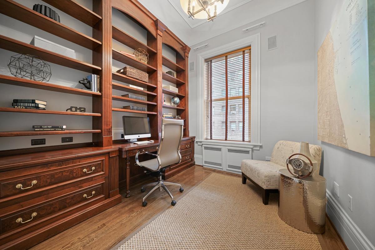 The office/library featuring period millwork enhances the unit’s functionality and elegance. (Courtesy of Americorp Ltd-Laricy)