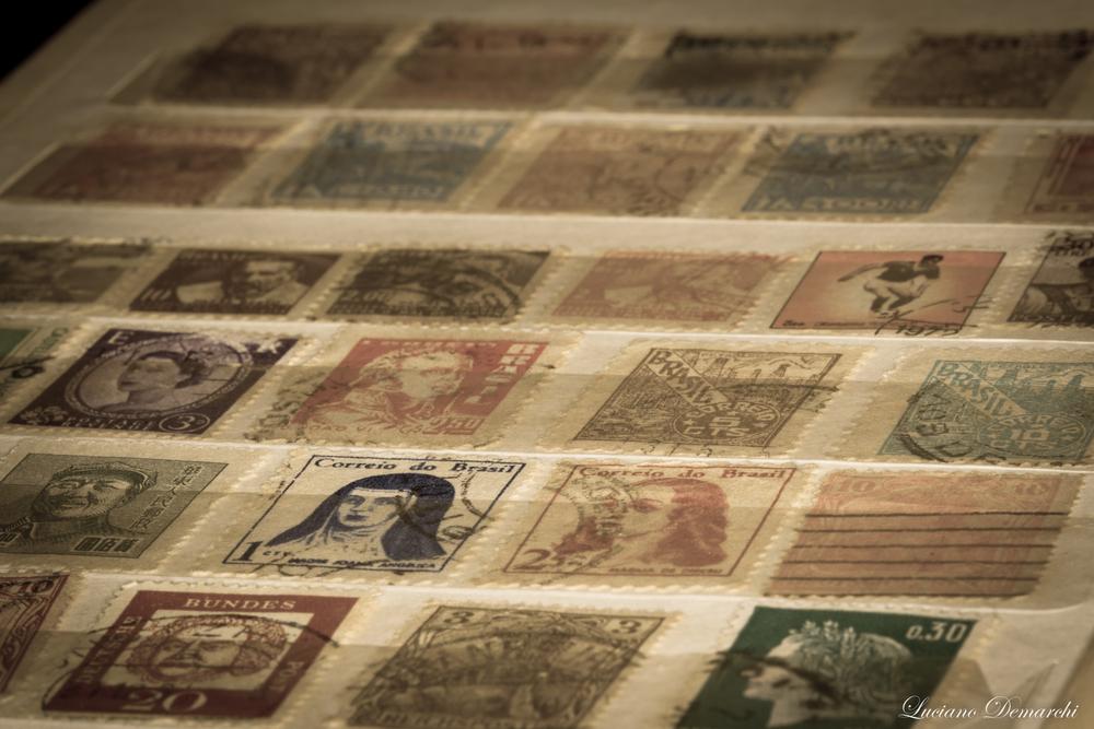 Some dealers and investors will spend many hours searching through stamp collections in hopes of finding that “needle in a haystack” stamp. (Luciano Demarchi/Shutterstock)