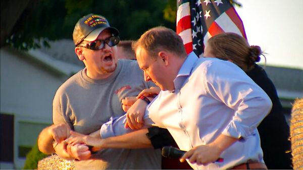 In this image taken from video, David Jakubonis (L) is subdued as he brandishes a sharp object during an attack on Rep. Lee Zeldin (R-N.Y.) as the Republican candidate for New York governor delivers a speech in Perinton, N.Y., on July 21, 2022. (WHEC-TV via AP)