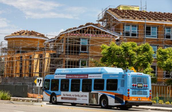 An OCTA bus drives past a construction project in Santa Ana, Calif., on July 25, 2022. (John Fredricks/The Epoch Times)
