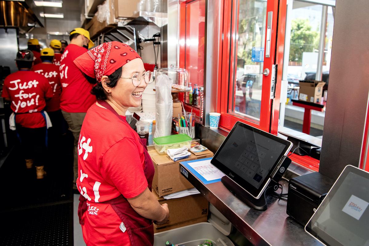 Former owner — and still figurehead — Sonia Hong, all smiles, stands at the register of the new Irv’s Burgers, taking orders and chatting with guests on opening day. (Mariah Tauger/Los Angeles Times/TNS)