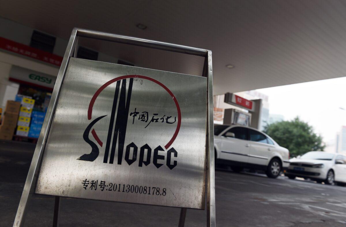 Cars line up to fill up with fuel at a Sinopec service station in Beijing on July 8, 2015. (Greg Baker/AFP via Getty Images)