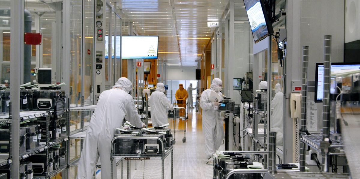 Workers work inside the clean room of U.S. semiconductor manufacturer SkyWater Technology Inc where computer chips are made in Bloomington, Minn., in April 2022. (SkyWater Technology/Handout via Reuters)
