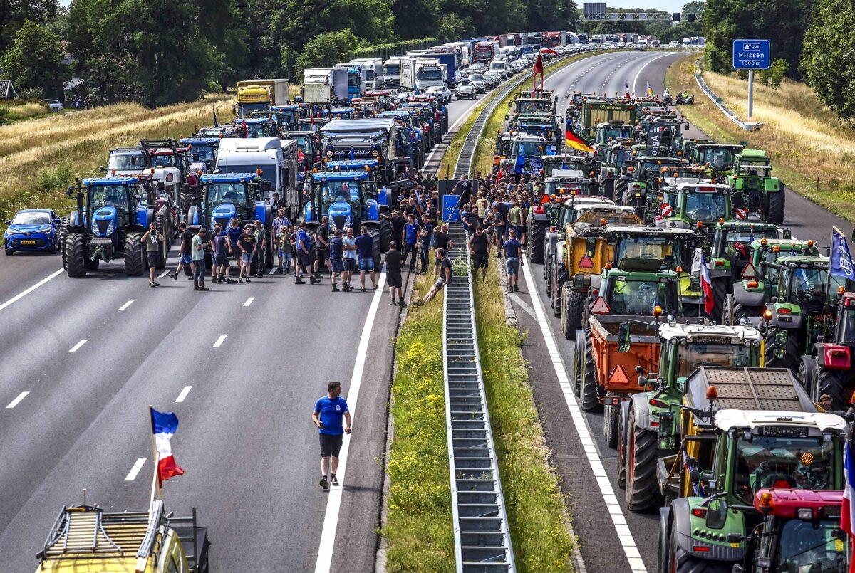 Farmers gather with their vehicles next to a Germany/Netherlands border sign during a protest on the A1 highway, near Rijssen, on June 29, 2022. (Vincent Jannink/ANP/AFP via Getty Images)