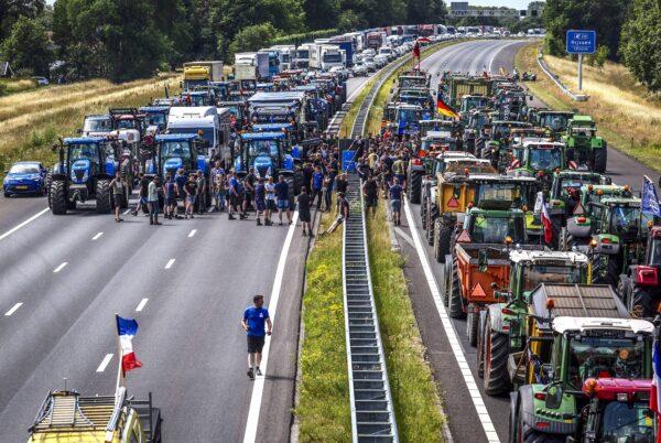 Farmers gather with their vehicles next to a Germany/Netherlands border sign during a protest on the A1 highway, near Rijssen, on June 29, 2022, against the Dutch Government's nitrogen plans. (VINCENT JANNINK/ANP/AFP via Getty Images)