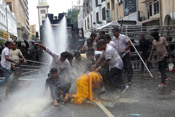 Police use water cannons to disperse farmers taking part in an anti-government protest demanding the resignation of Sri Lanka's President Gotabaya Rajapaksa over the country's economic crisis in Colombo on July 6, 2022. (-/AFP via Getty Images)