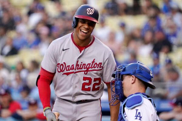 Washington Nationals' Juan Soto, left, laughs as he talks to Los Angeles Dodgers catcher Will Smith as he bats during the first inning of a baseball game, in Los Angeles, on Monday, July 25, 2022. (Mark J. Terrill/AP Photo)
