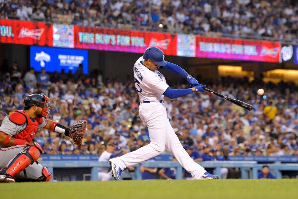 Los Angeles Dodgers' Trayce Thompson, right, hits a solo home run as Washington Nationals catcher Keibert Ruiz watches during the third inning of a baseball game, in Los Angeles, on Monday, July 25, 2022. (Mark J. Terrill/AP Photo)