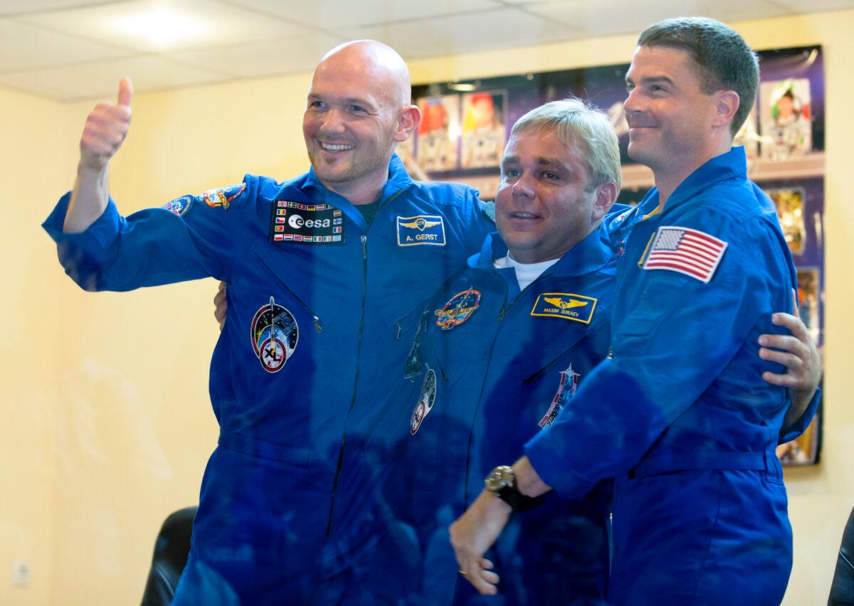 European Space Agency's astronaut Alexander Gerst (L), Russian cosmonaut Maxim Suraev (C), and NASA astronaut Reid Wiseman, members of the next mission to the International Space Station, embrace during a news conference in Russian leased Baikonur cosmodrome, Kazakhstan, on May 27, 2014. (Dmitry Lovetsky/AP Photo)
