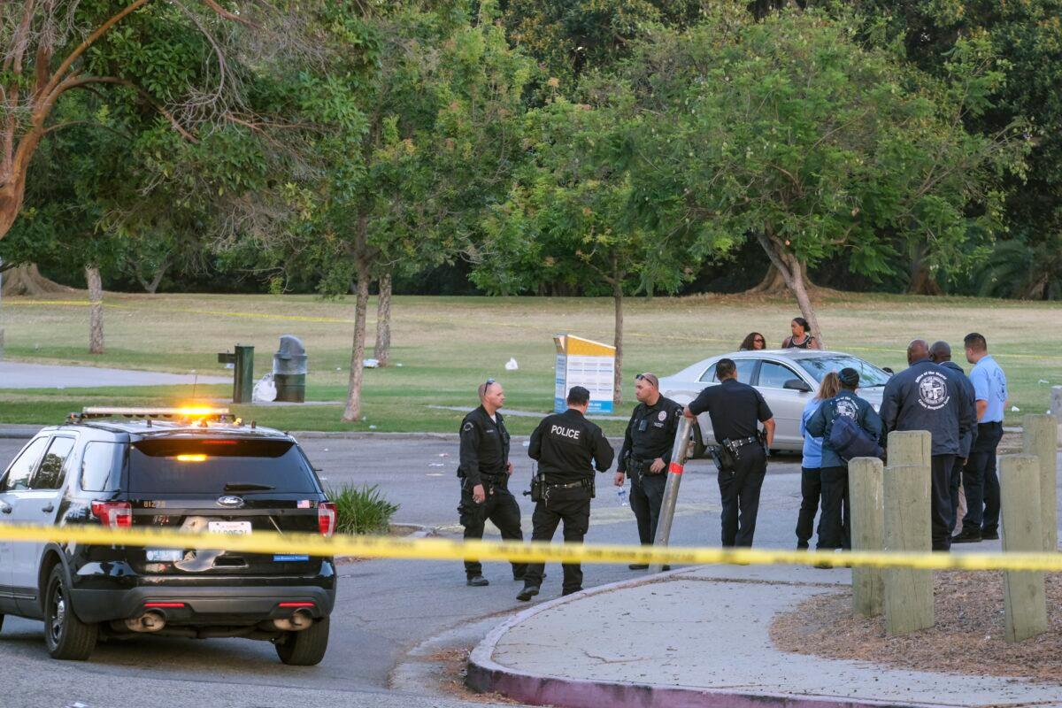 Police officers stand near the scene of a shooting at Peck Park in San Pedro, Calif., on July 24, 2022. (Ringo H.W. Chiu/AP Photo)