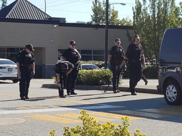 Police look for evidence at the site of the shootings in Langley on July 25, 2022. (Jeff Sandes/The Epoch Times)
