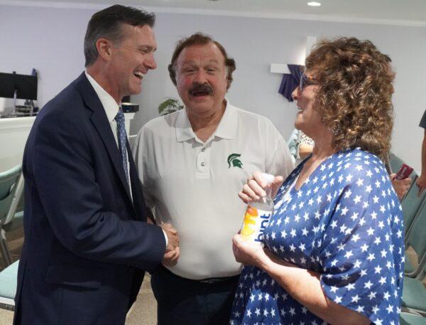 GOP candidate for governor of Michigan Ralph Rebandt (L) talks to voters at the Saving Michigan for God and Country Rally in Swartz Creek, Mich., on July 22, 2022. (Steven Kovac/Epoch Times)