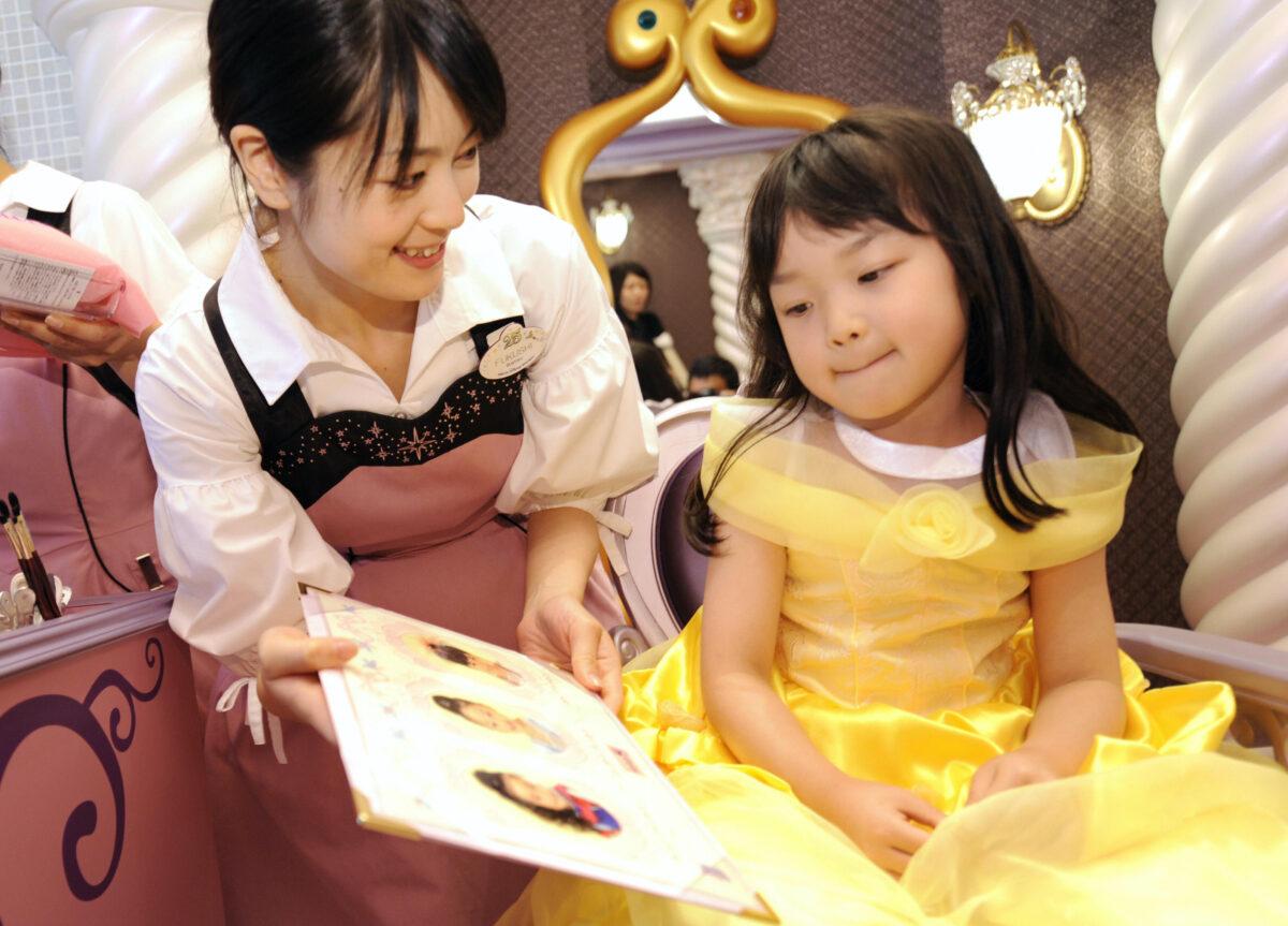 A girl chooses her hair style at the "Bibbidi Bobbidi Boutique" at Tokyo Disneyland hotel in Urayasu, Japan on July 2, 2008. (Yoshikazu Tsuno/AFP via Getty Images)