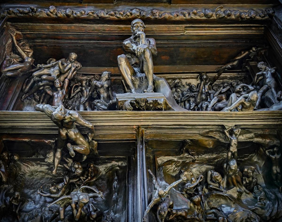 "The Thinker" sitting above the doors, in the tympanum, of the monumental brass sculptural work "The Gates of Hell" inspired by a scene from the "Inferno," the first section of Dante Alighieri's "Divine Comedy." (Allie Caulfield/CC BY 2.0)