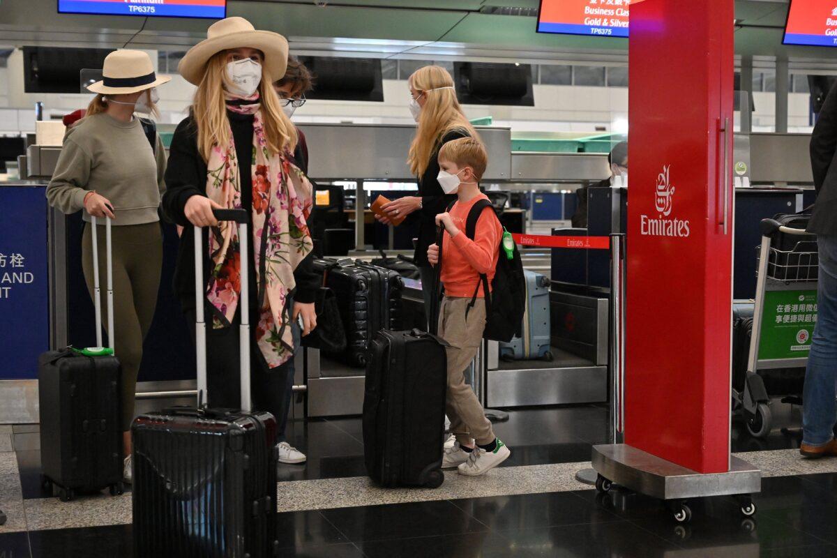 Expat families line up at the check-in counter at Hong Kong's Chek Lap Kok international airport on March 6, 2022. Travel restrictions have hit Hong Kong's white collar "expat" foreign workers hard. (Peter Parks/AFP via Getty Images)