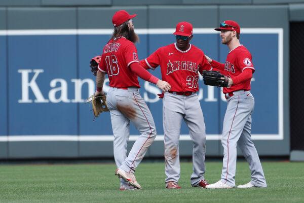 Outfielders Brandon Marsh #16, Magneuris Sierra #37, and Taylor Ward #3 of the Los Angeles Angels congratulate each other after the Angels defeated the Kansas City Royals 4-0 to win the game at Kauffman Stadium in Kansas City, Mo, on July 27, 2022. (Jamie Squire/Getty Images)