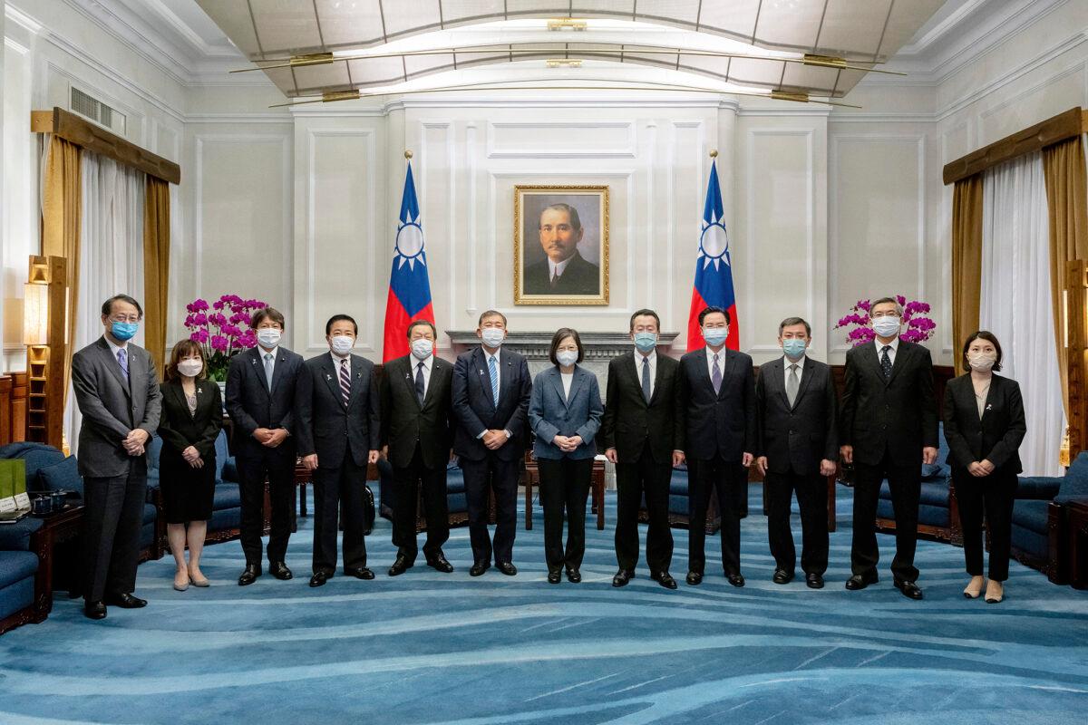 Taiwan's President Tsai Ing-wen (center) and Taiwanese officials pose for photos with a Japanese delegation at the presidential office in Taipei, Taiwan, on July 28, 2022. (Taiwan Presidential Office via AP)