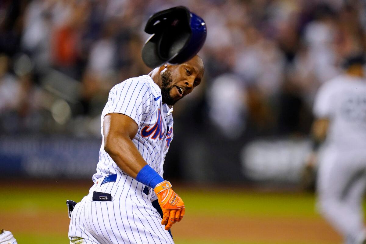 New York Mets' Starling Marte tosses his helmet after hitting a single against the New York Yankees to drive in the winning run during the ninth inning of a baseball game in New York on July 27, 2022. (Frank Franklin II/AP Photo)