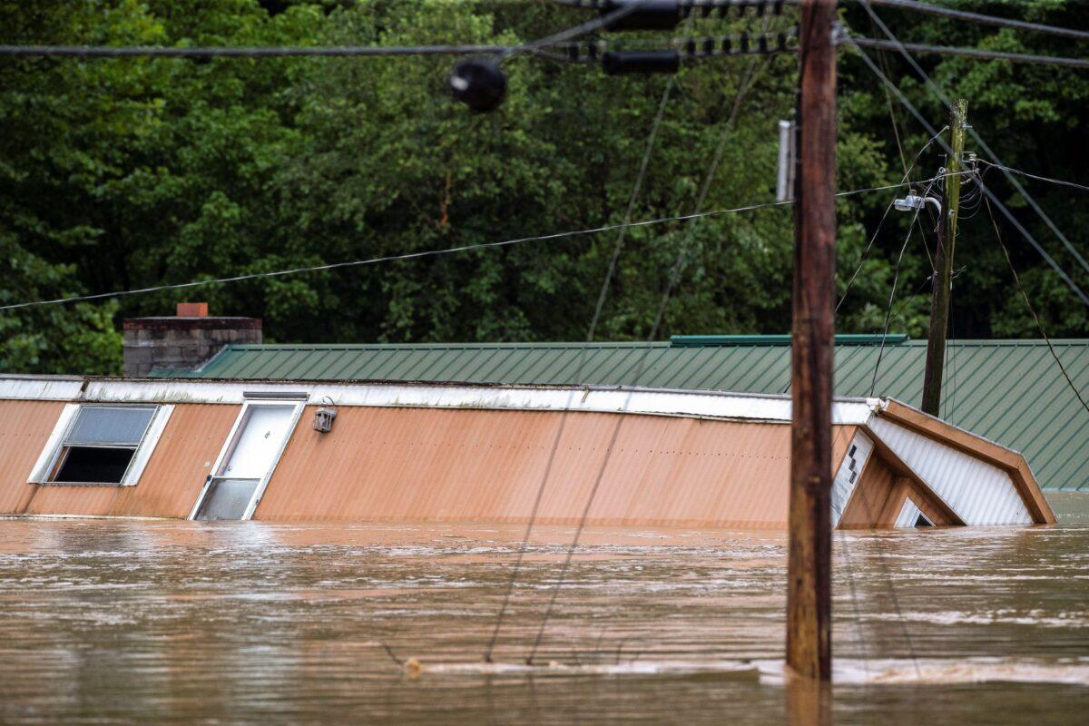 Homes are flooded by Lost Creek, Ky., on July 28, 2022. (Ryan C. Hermens/Lexington Herald-Leader via AP)