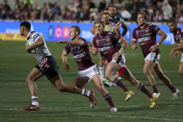 Daly Cherry-Evans (2nd L) of the Sea Eagles, wearing a rainbow-trimmed Pride jersey, defends during the rugby league match between the Manly Sea Eagles and Sydney Roosters in Sydney, Australia, on July 28, 2022. (Glenn Nicholls/AFP via Getty Images)