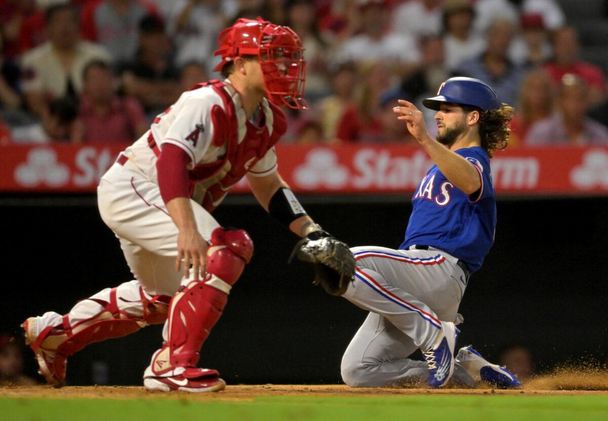 Josh Smith #47 of the Texas Rangers scores against Max Stassi #33 of the Los Angeles Angels on a double by Corey Seager #5 in the fifth inning at Angel Stadium of Anaheim in Anaheim, Calif., on July 28, 2022. (Jayne Kamin-Oncea/Getty Images)