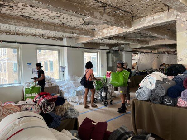 College freshmen browse through recycled dorm items during the Grad Bag event in New York City on July 28, 2022. (Madalina Vasiliu/The Epoch Times)