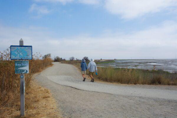 A couple walks along the Adobe Creek Loop Trail with the Charleston Slough on the right. (Courtesy of Karen Gough)