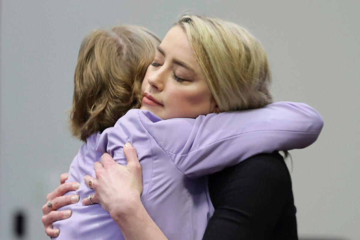 Actress Amber Heard hugs her lawyer Elaine Bredehoft after the verdict was read at the Fairfax County Circuit Courthouse in Fairfax, Va., on June 1, 2022. (Evelyn Hockstein/Pool via AP)