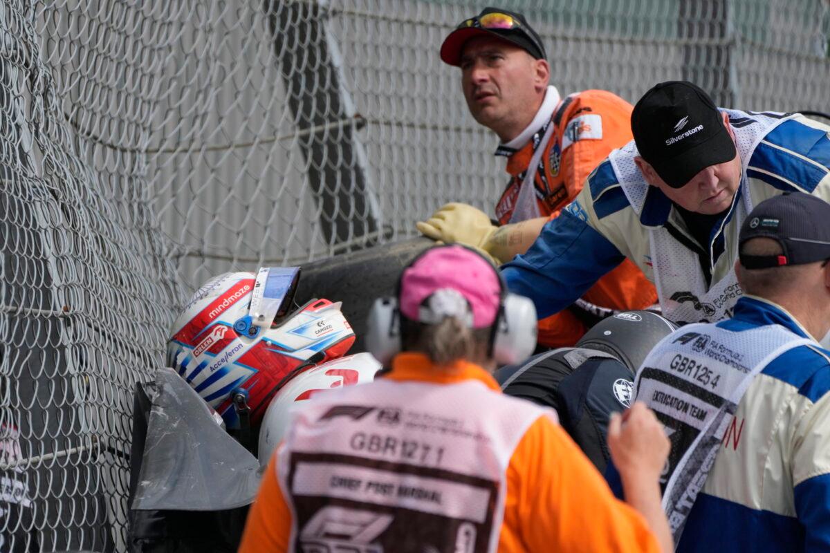 Alfa Romeo driver Guanyu Zhou of China (L) receives medical treatment after he was involved in a crash at the start of the British Formula One Grand Prix at the Silverstone circuit in Silverstone, England, on July 3, 2022. (Frank Augstein/AP Photo)