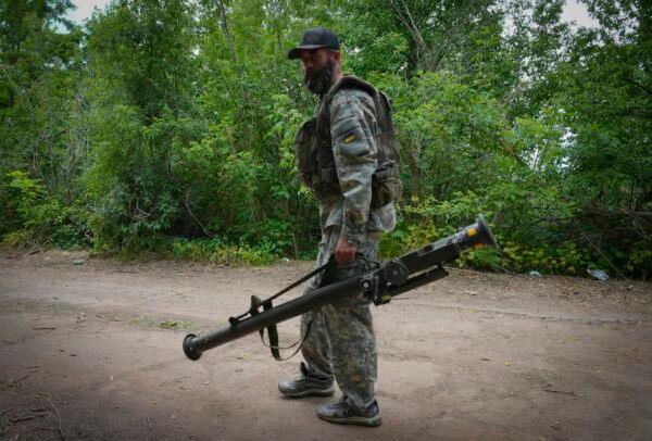 A Ukrainian soldier carries a U.S.-supplied Stinger as he goes along the road in Ukraine's eastern Donetsk region on June 18, 2022. (Efrem Lukatsky/AP Photo)