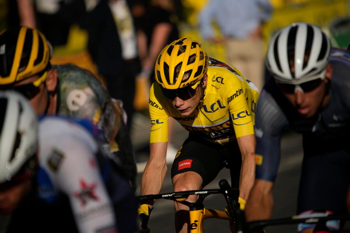 Denmark's Jonas Vingegaard, wearing the overall leader's yellow jersey, and Netherlands' Bauke Mollema (R) ride during the twenty-first stage of the Tour de France cycling race over 116 kilometers (72 miles) with start in Paris la Defense Arena and finish on the Champs Elysees in Paris, on July 24, 2022. (Daniel Cole/AP Photo)